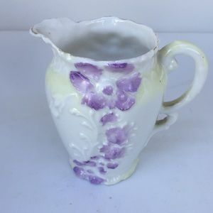 Sweet creamer with purple flowers.